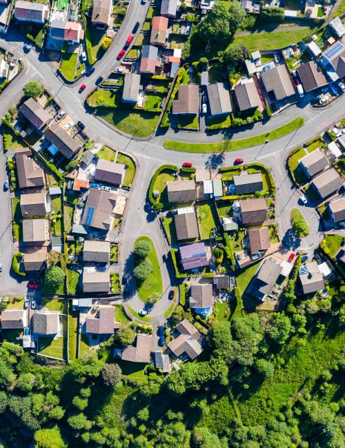 Aerial view of housing estate with houses and roads and local infrastructure