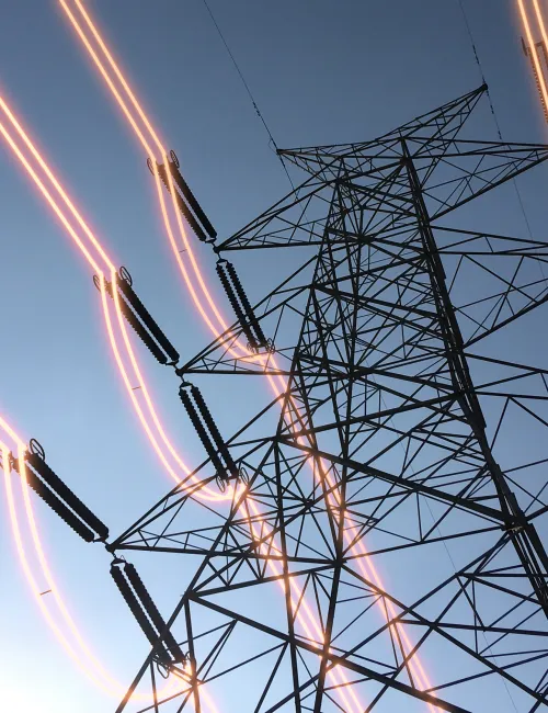 Electricity transmission towers with glowing wires