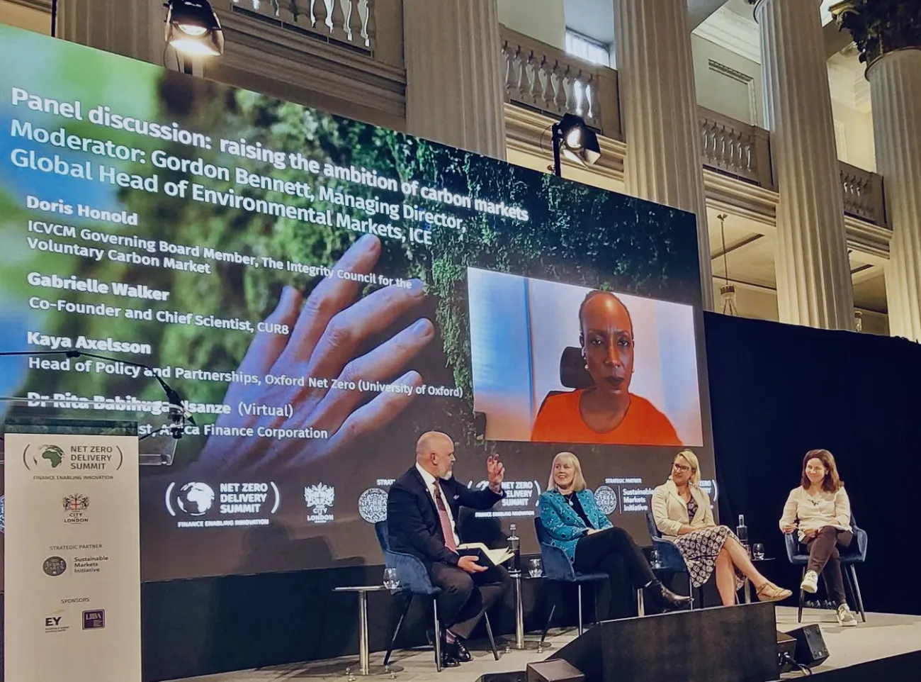 Panel sitting in front of large screen at the Summit