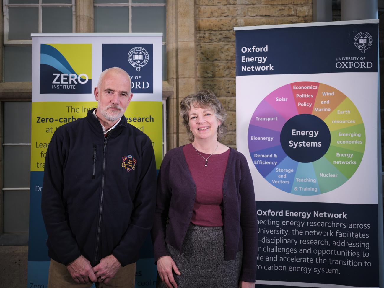 Dr Nick Banks and Dr Tina Fawcett standing in front of display banners
