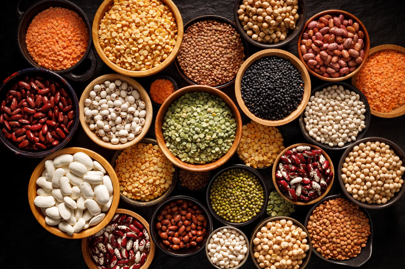 Legumes, a set consisting of different types of beans, lentils and peas on a black background
