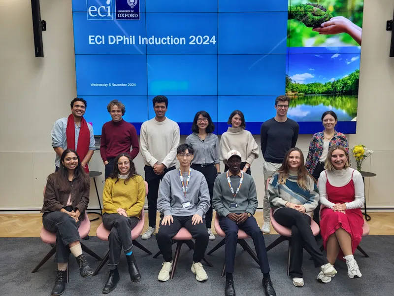 Group shot of current and new DPhil students in front of presentation screen