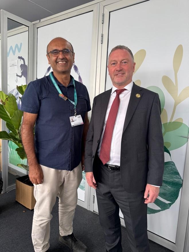 Prof Malhi stood next UK Secretary of State Steve Reed