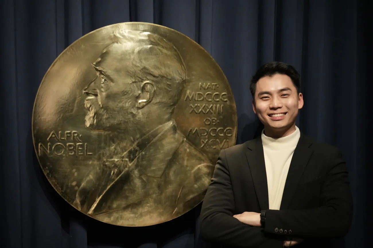 Max Han standing next to the sign for the Nobel Prize Museum