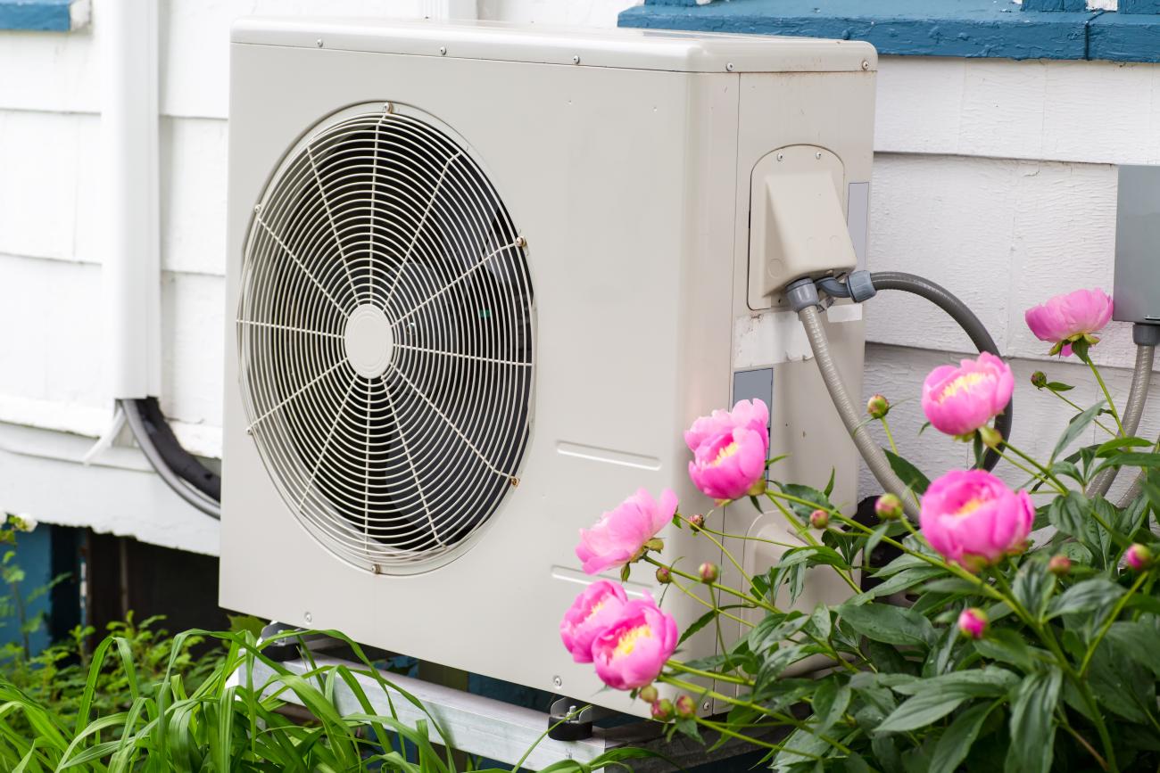 Heat pump among the flowers in a garden