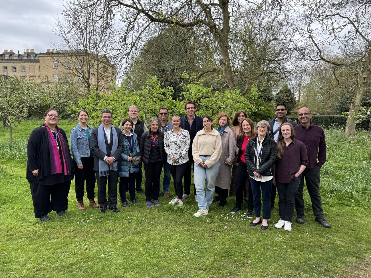 The team of experts standing together in the park for a group photo