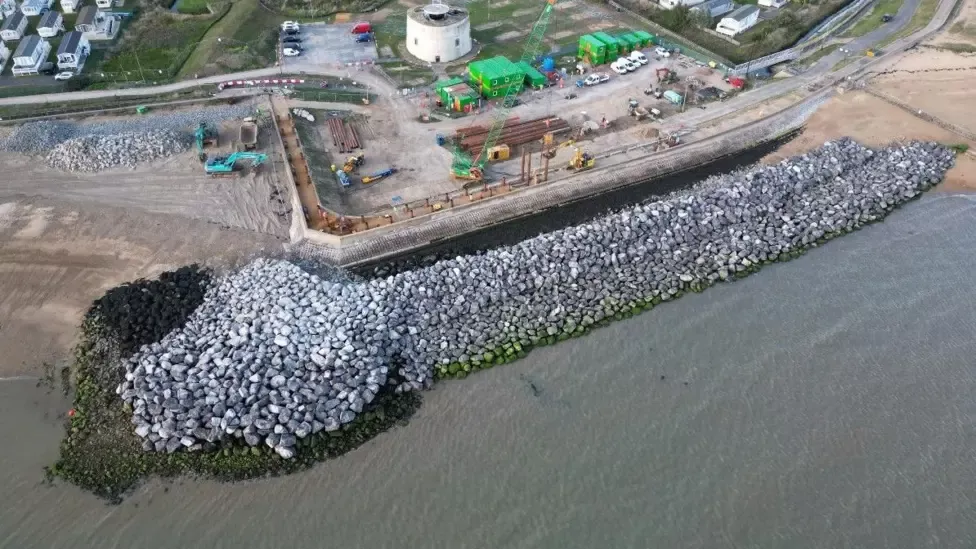 Aerial shot of granite at Cockett Wick on the Essex coast forming flood defence