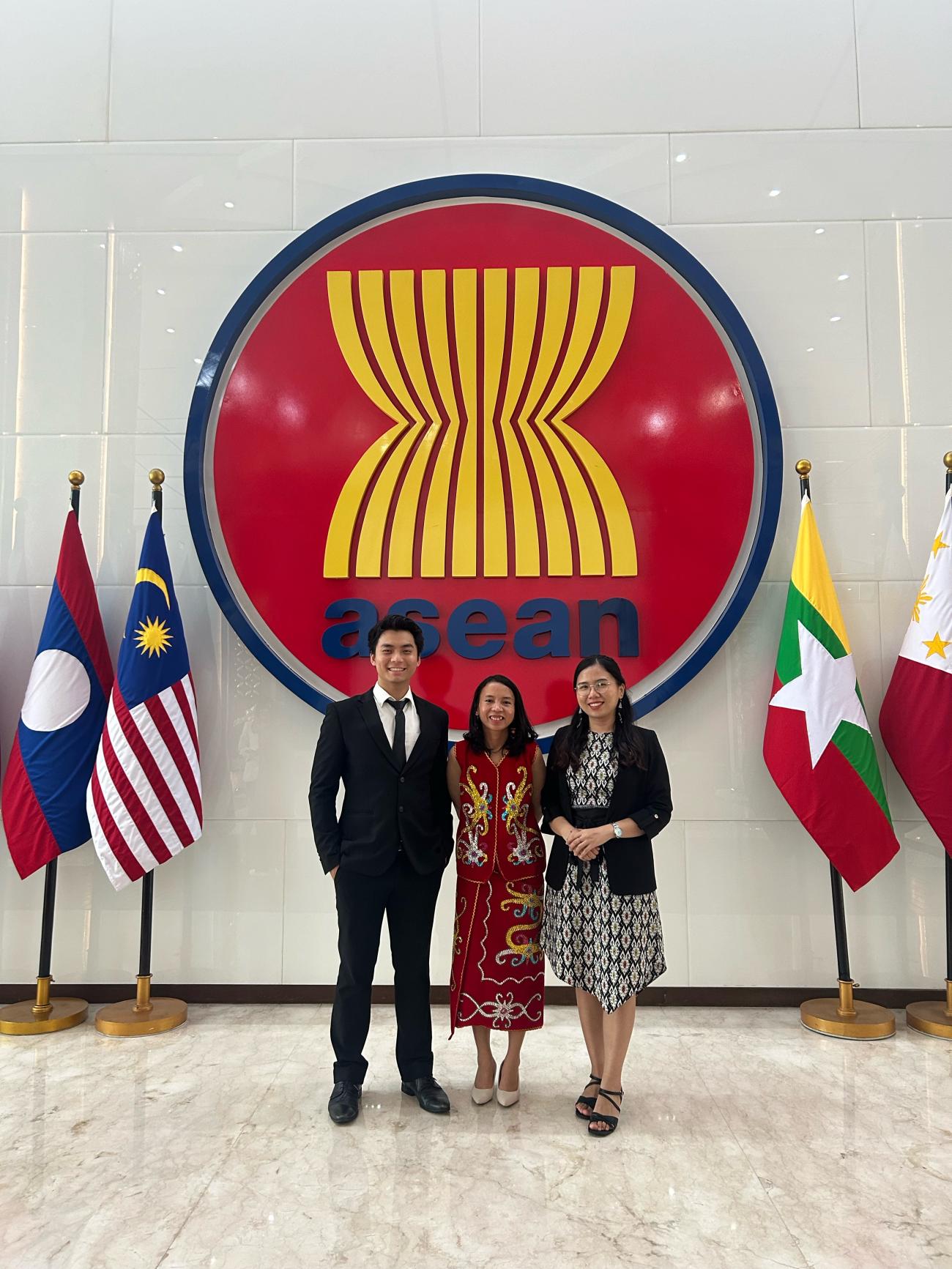 Max posing with two women at the ASEAN Headquarters in Jakarta, Indonesia