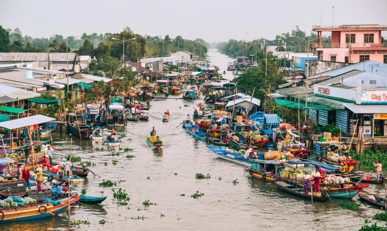 Local people living and working on boats on the Nga Nam Floating Market in Mekong Delta, Vietnam