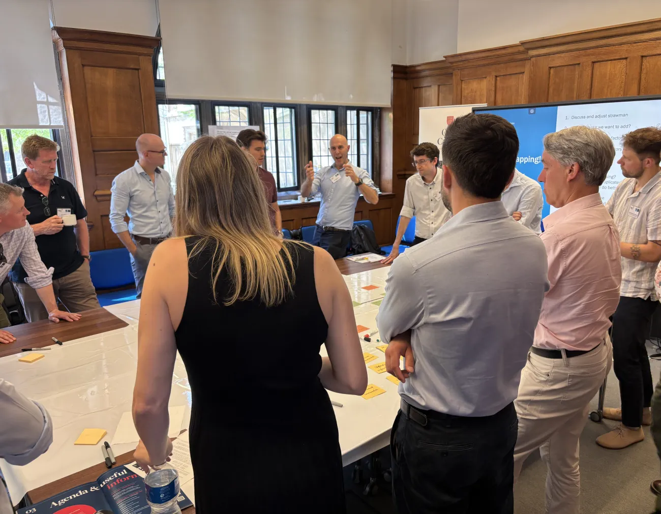 Workshop participants gathered around a table and discussing ideas