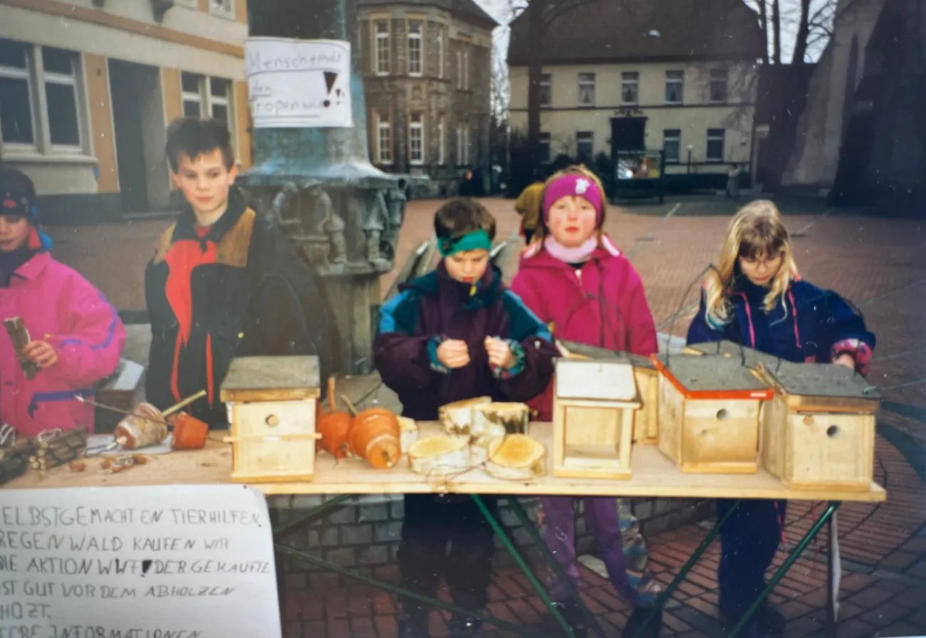 Children at a table showing bird boxes