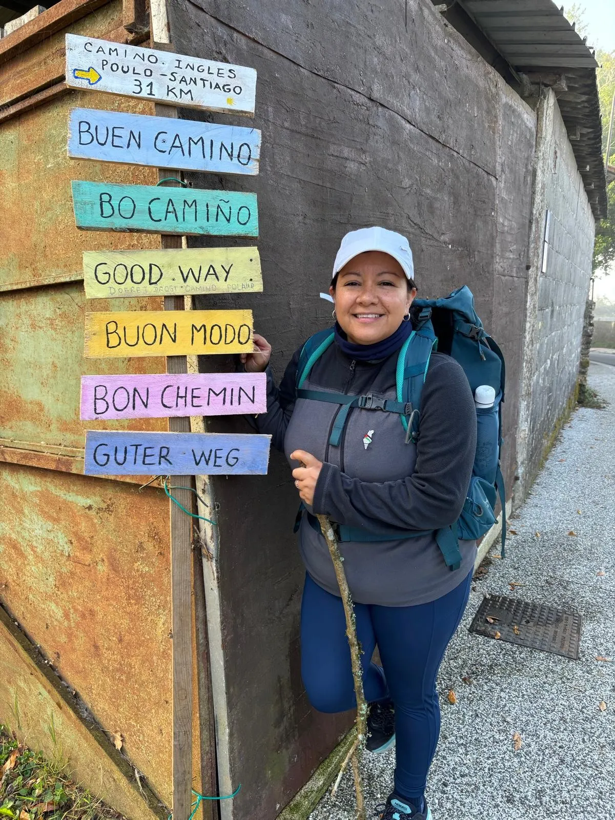 Angela Soasti Pozo standing next to a signpost along the route