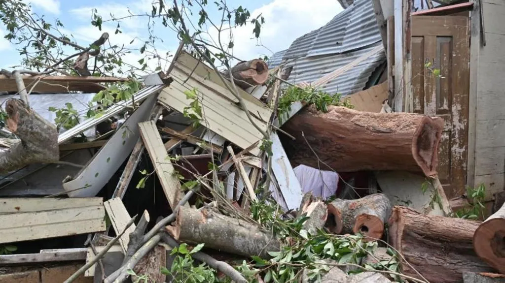 Damage piled up in street where homes once were