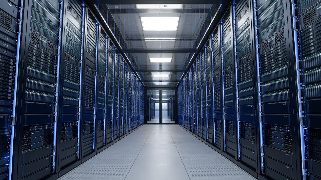 The inside of a large data centre showing a corridor with server racks and cabinets full of hard drives