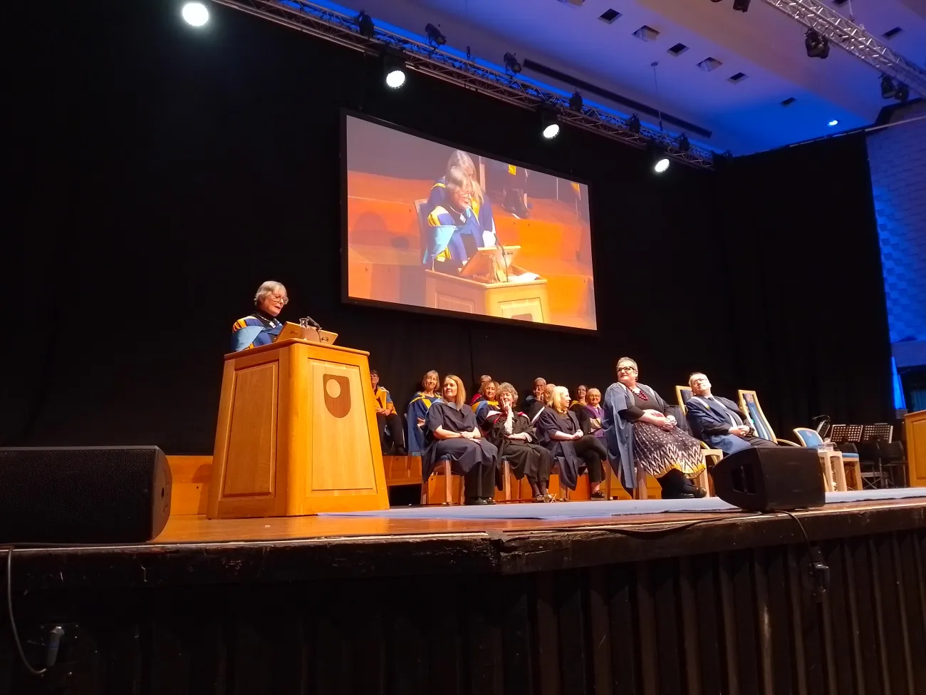 Dr Brenda Boardman delivering her acceptance speech at the podium on stage