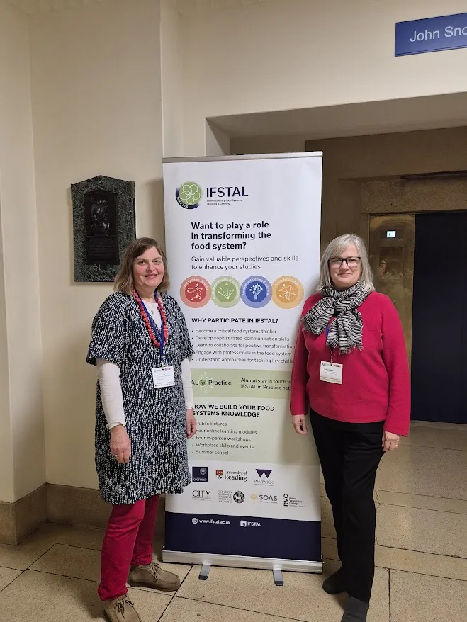 Dr Monkia Zurek and Dr Rebecca Wells stood next to an IFSTAL banner