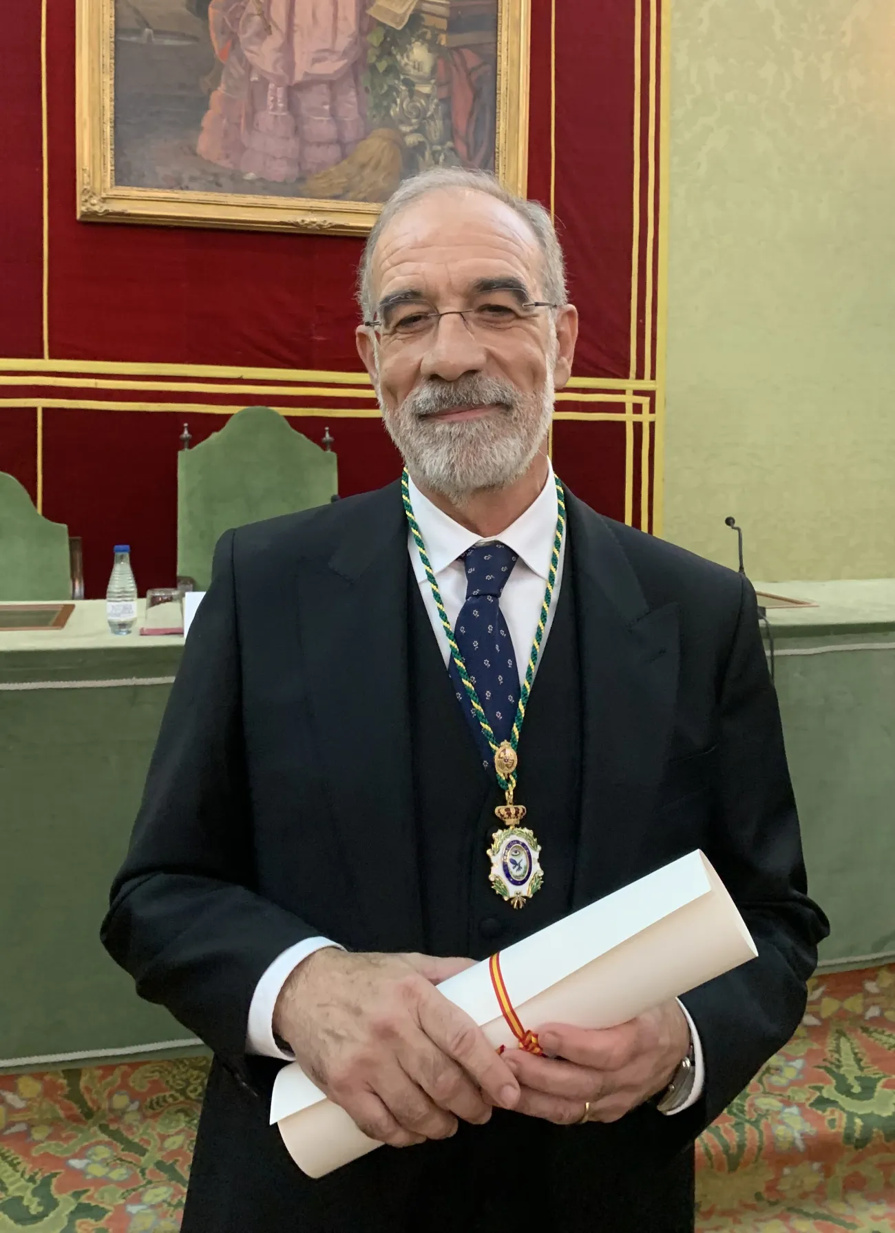 Professor Emilio Chuvieco holding a scroll and wearing a medal