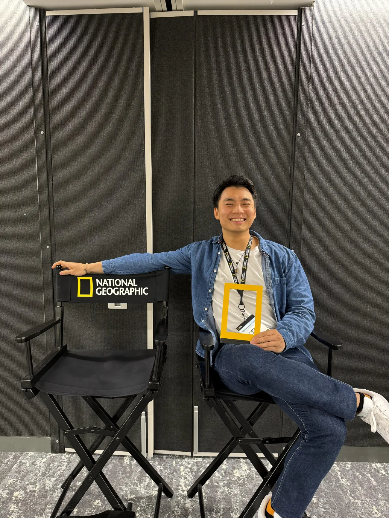 Max Han sat on a chair at the National Geographic headquarters smiling