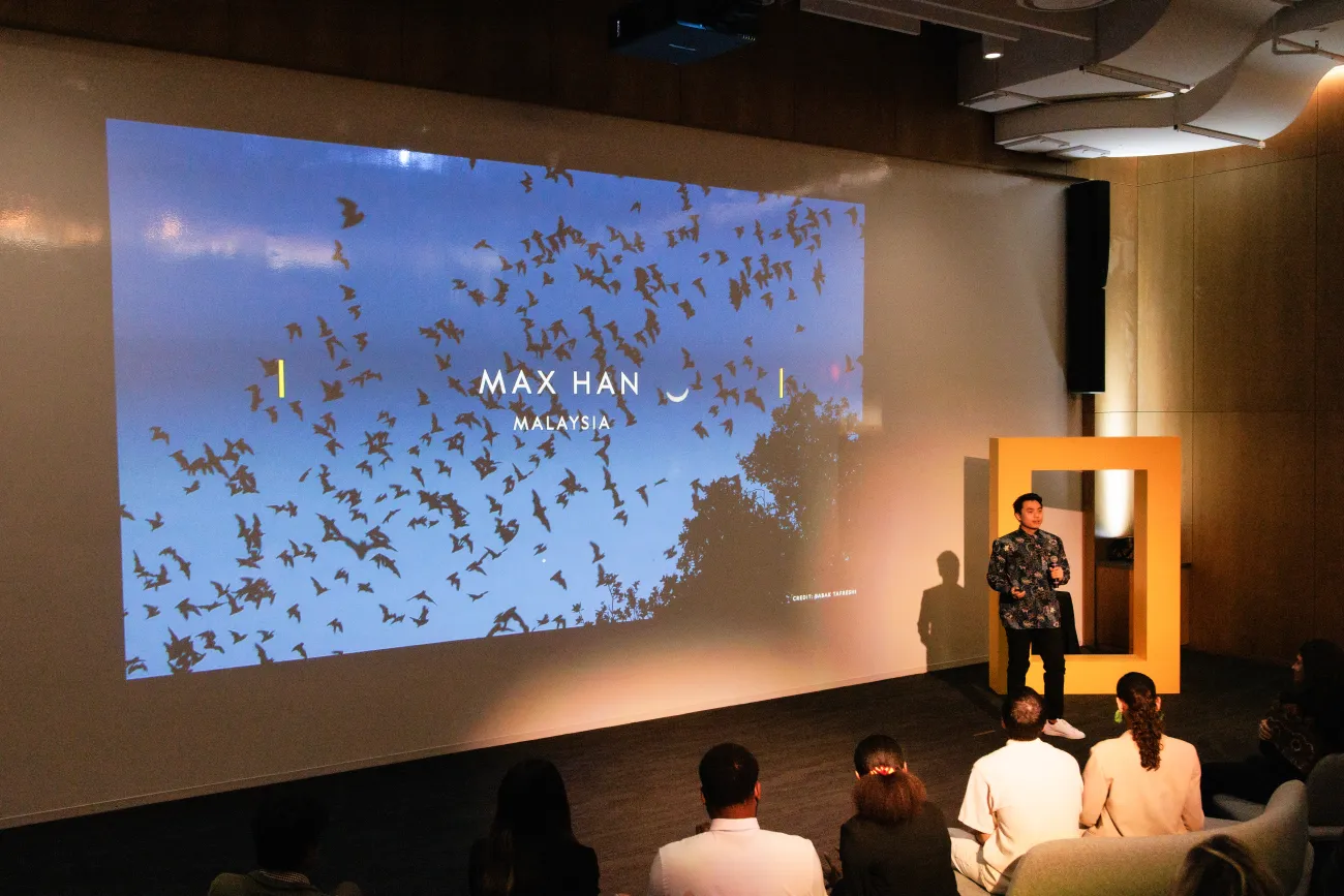 Max Han presenting on a stage