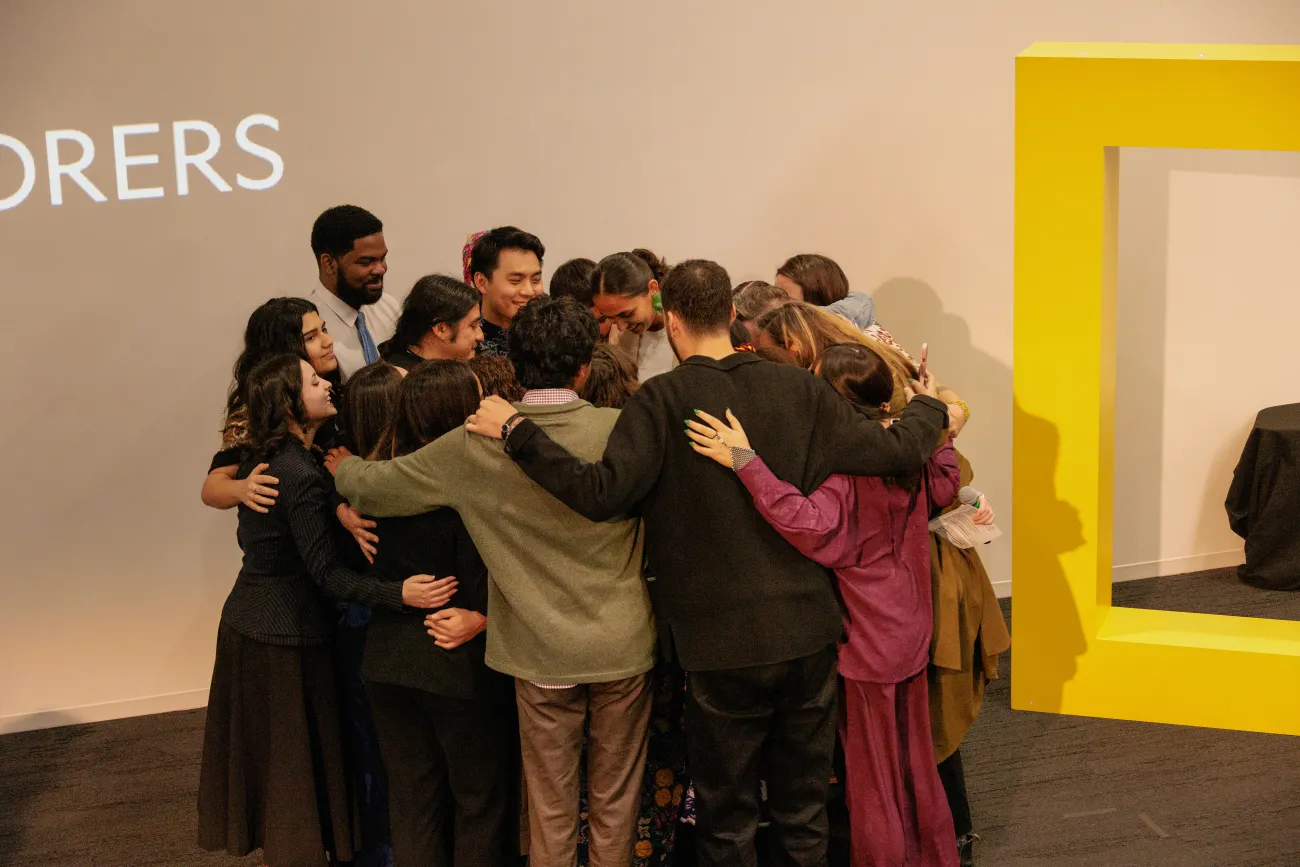 Max and other members of the trip hugging in a circle facing inwards