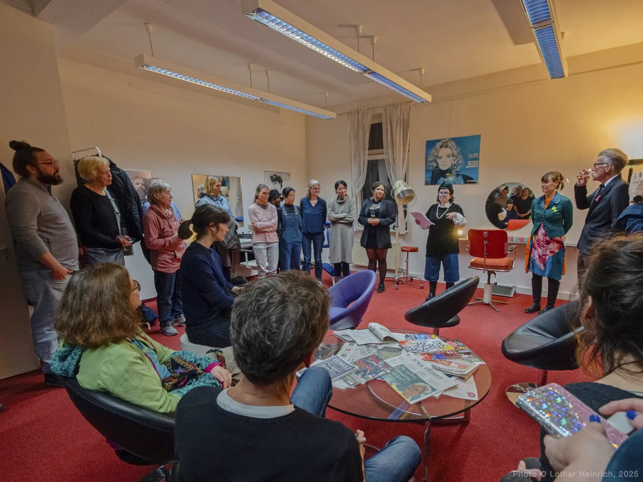 Group of people gathered for the opening event at the art installation