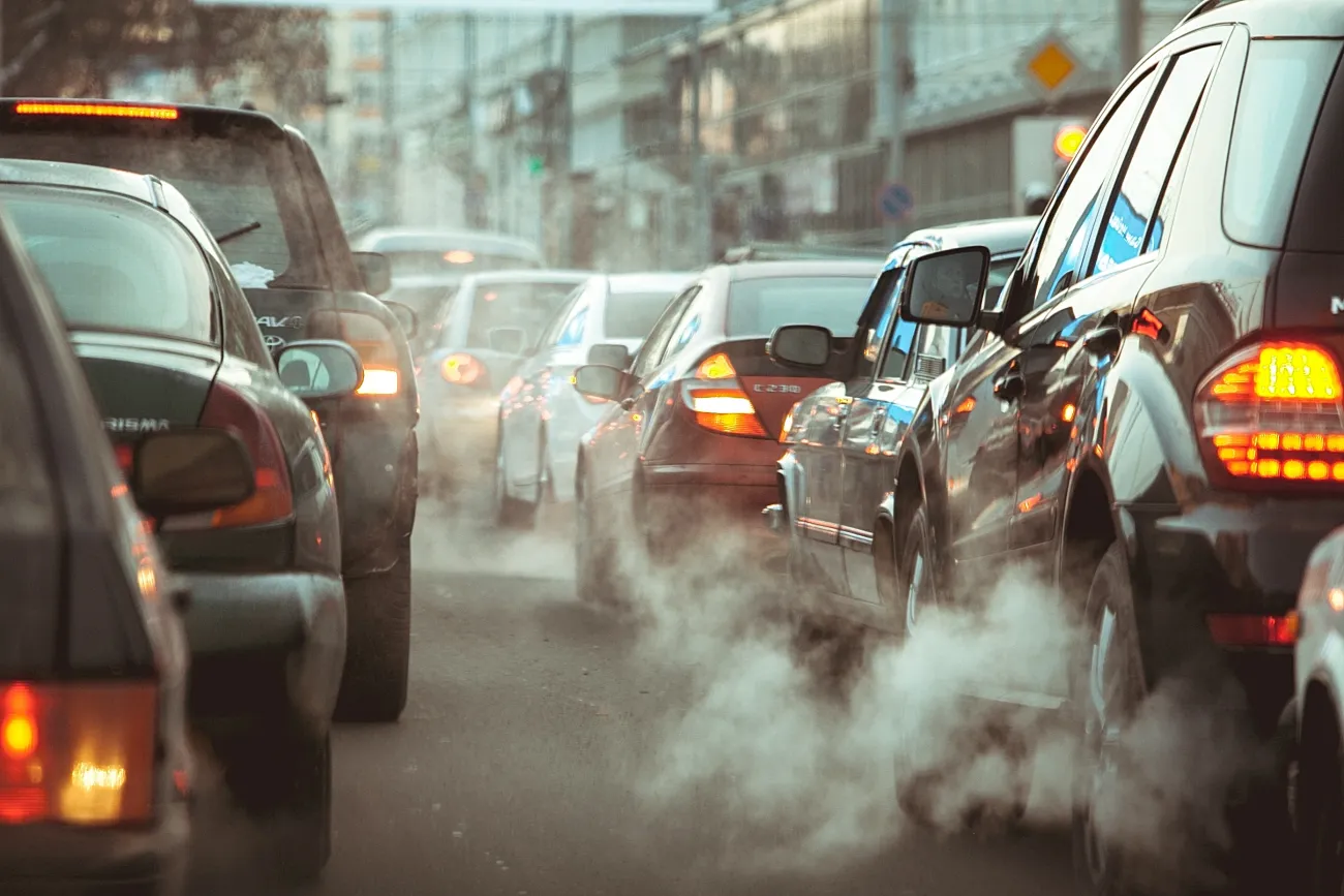 Vehicles in traffic jam with polluting exhaust smoke