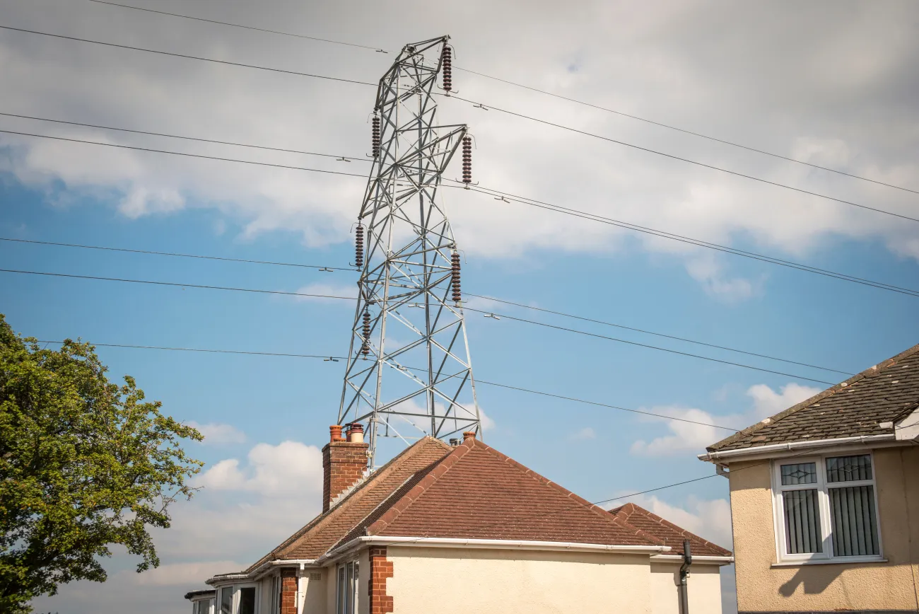 Pylon above rooftops of houses in UK