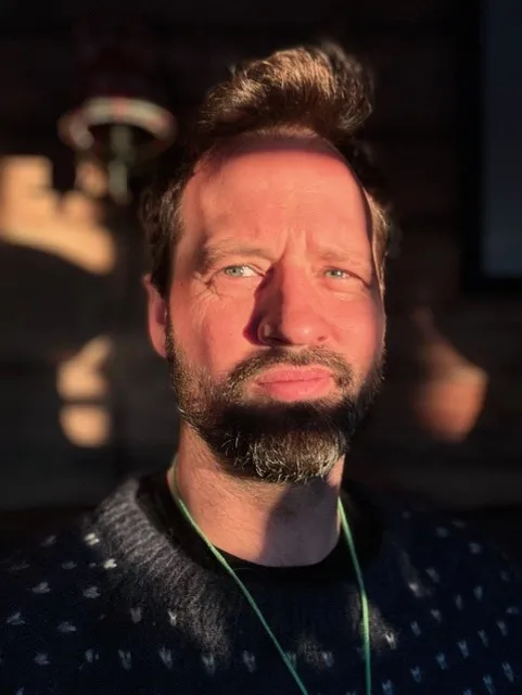 Dr Jake Barnes looking into distance with thoughtful expression