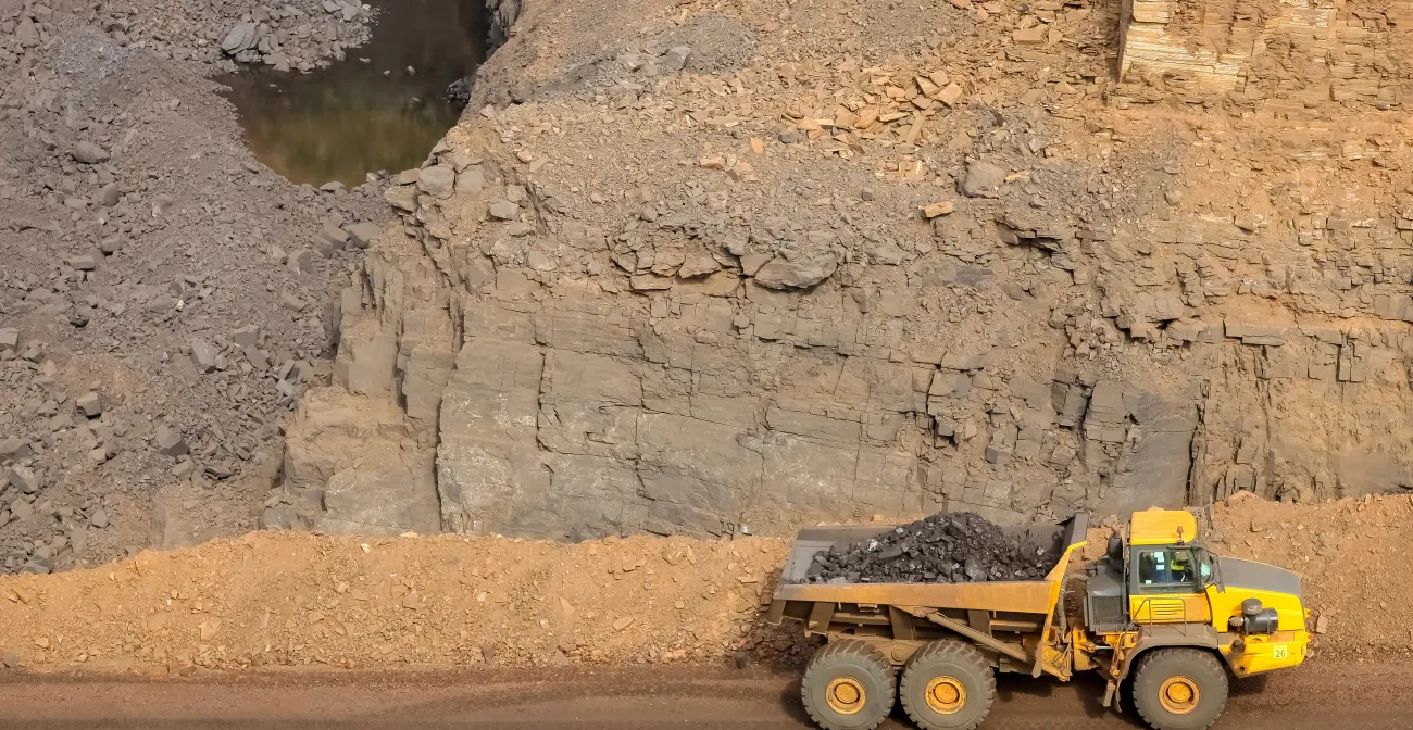 A tractor carrying a load in a mining area