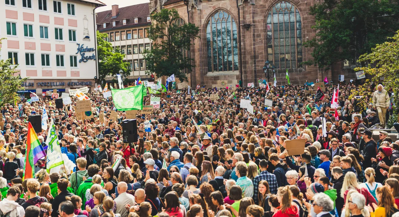 Large crowd of climate campaigners showing mainly heads in a sea of bodies