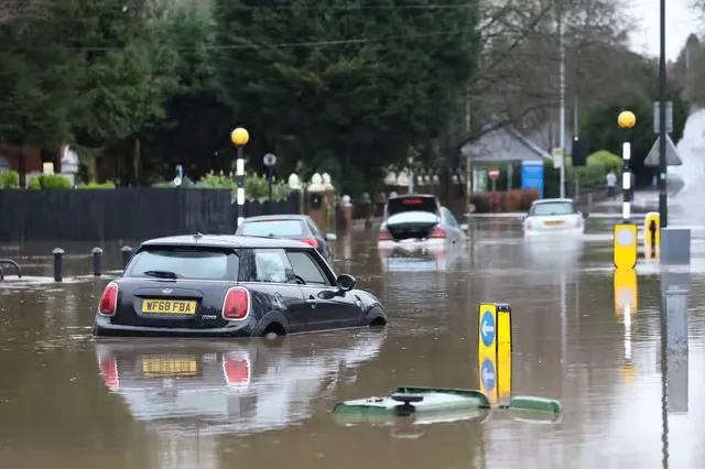 Cars on a road submerged in water. Stranded due to the flooding.