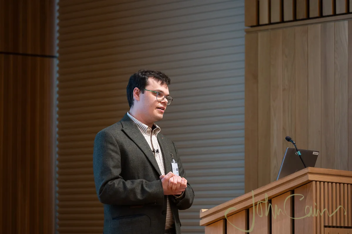 Dr Stuart Jenkins at a podium addressing the room