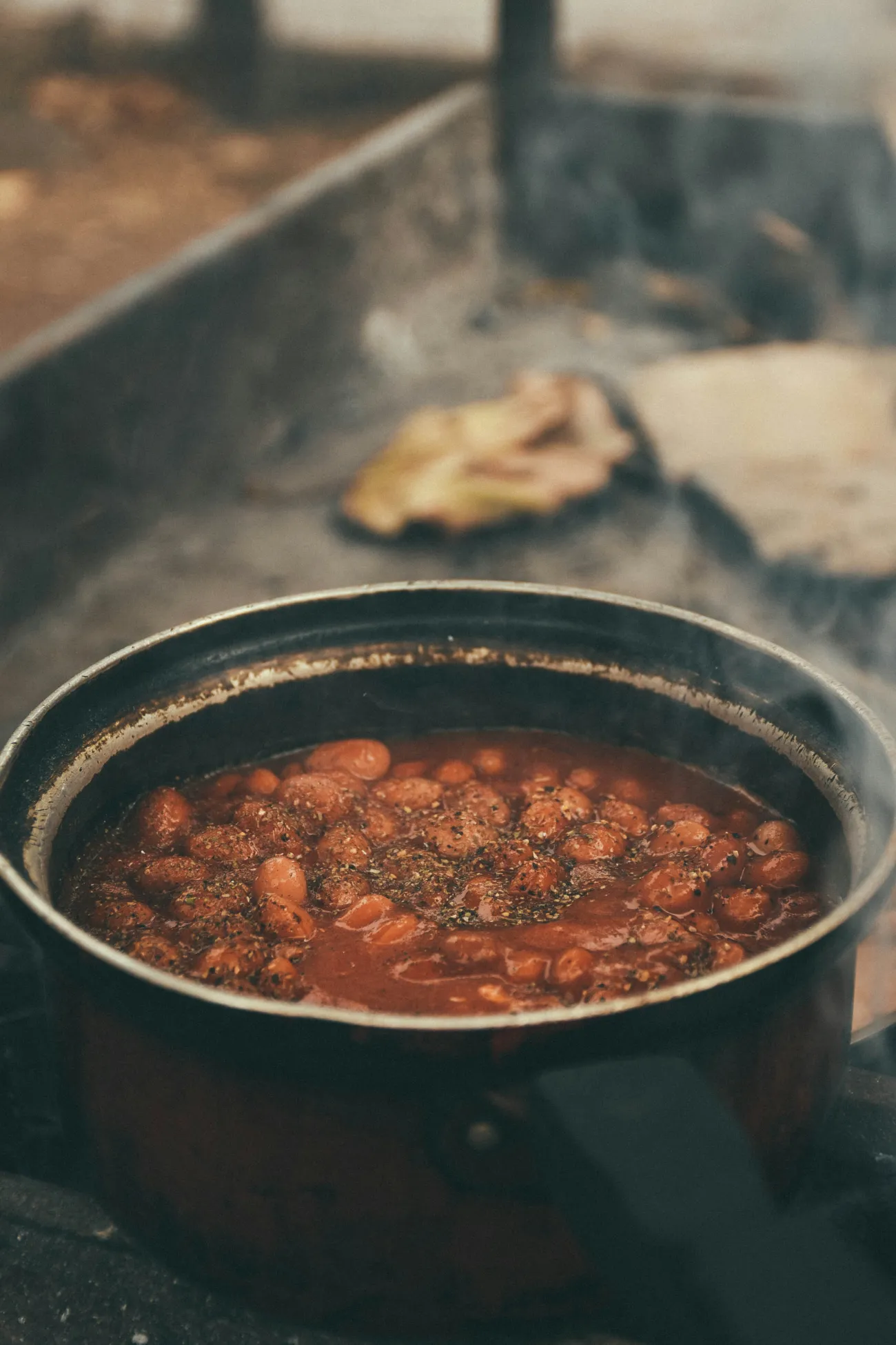 A hot meal cooking on a stove made up of various beans