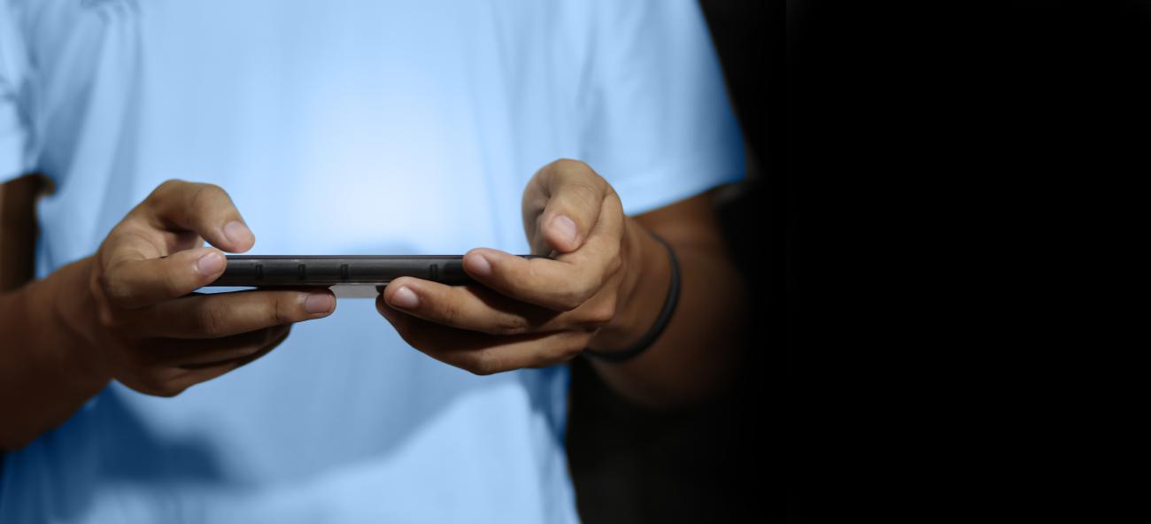Close up of man using a mobile smart phone showing hands and device