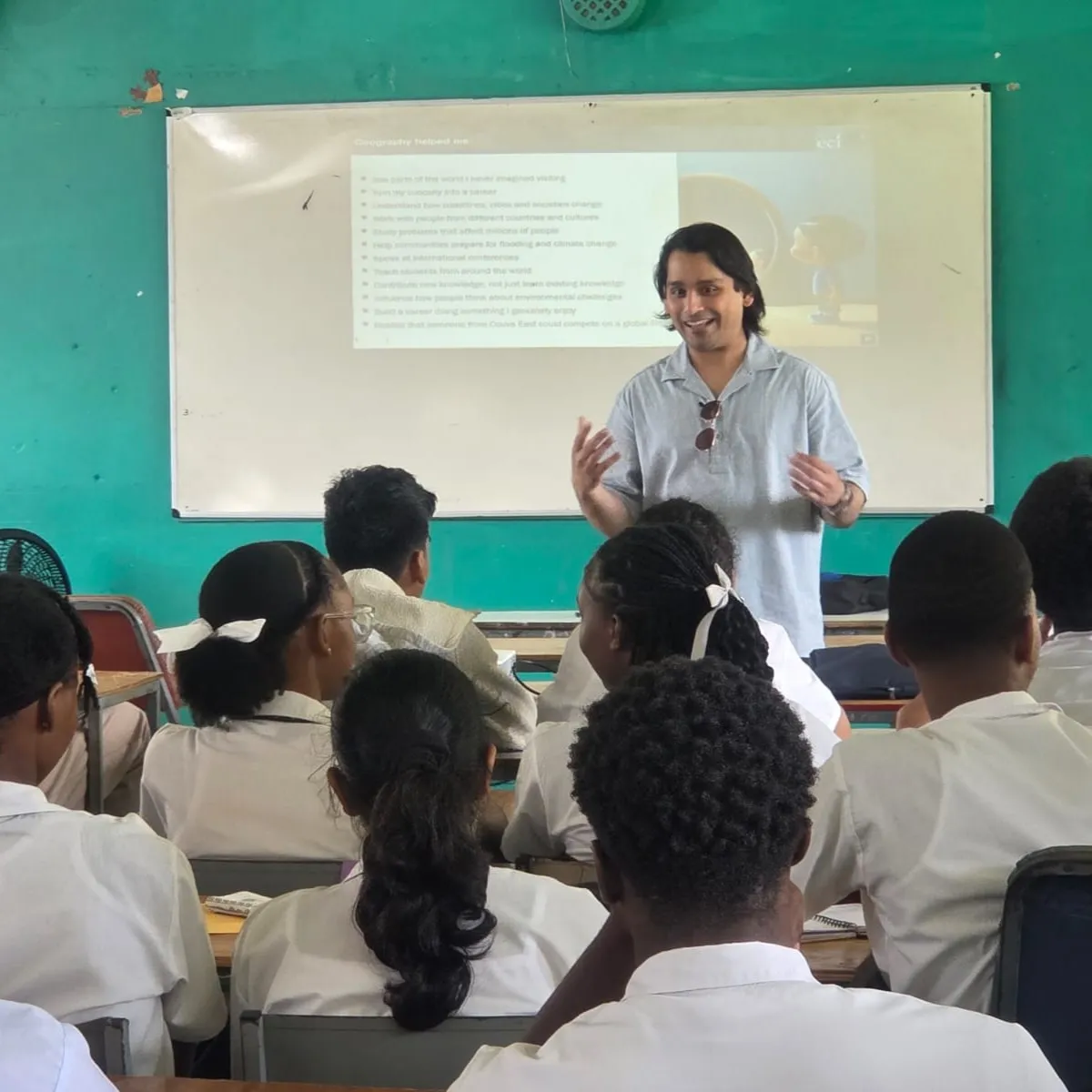Dr Avidesh Seenath standing at front of a classroom speaking to students