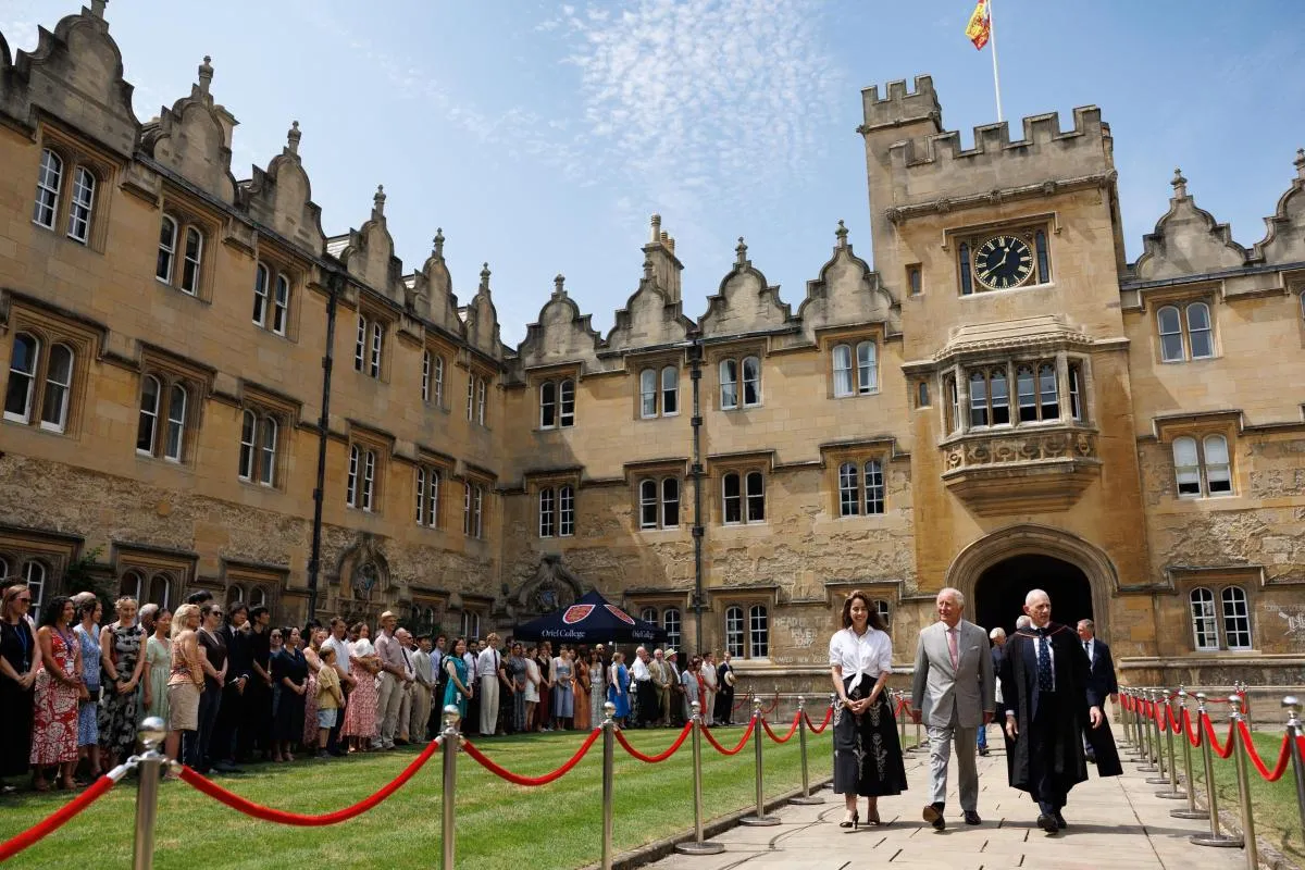 HRH King Charles walking from the entrance of Oriel College