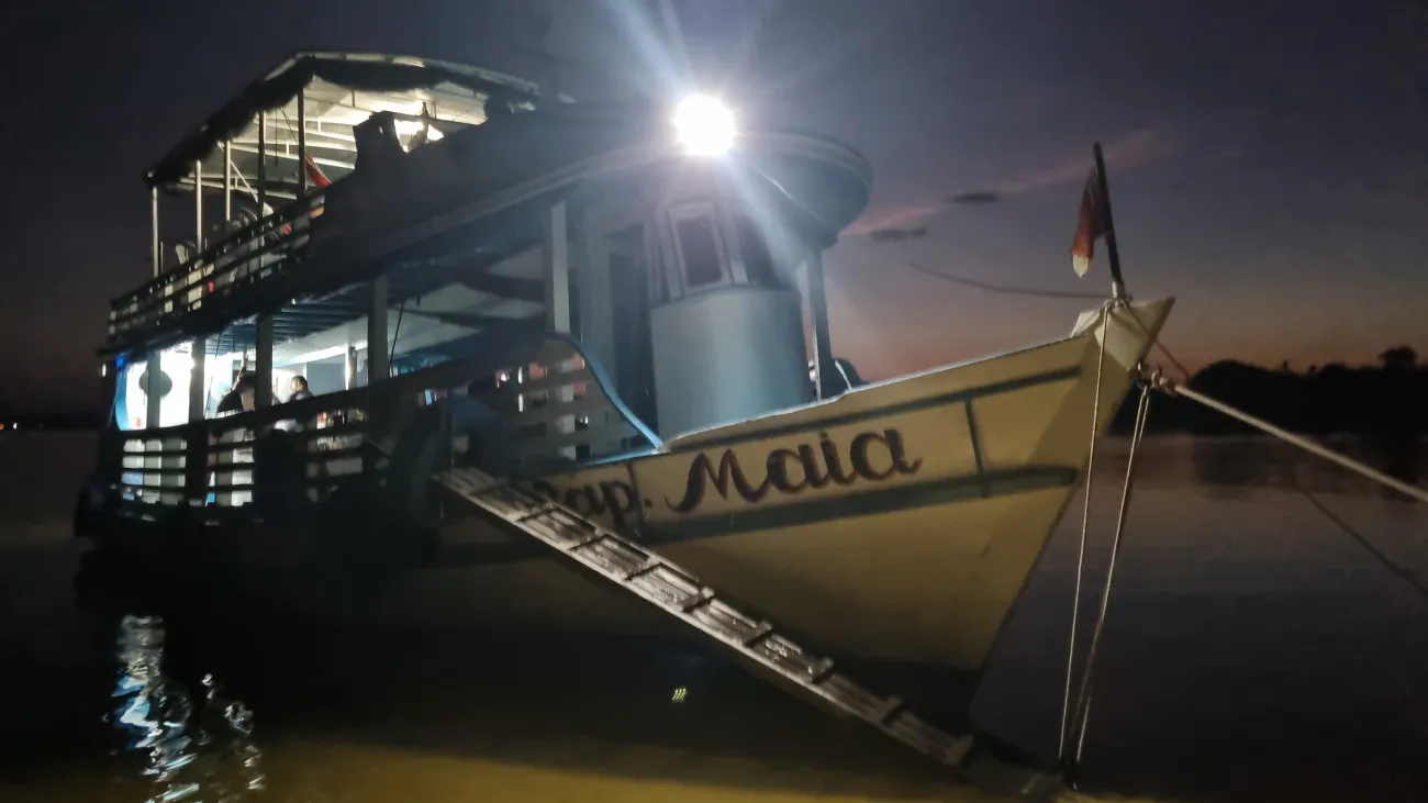 Boat at night in dark with a light