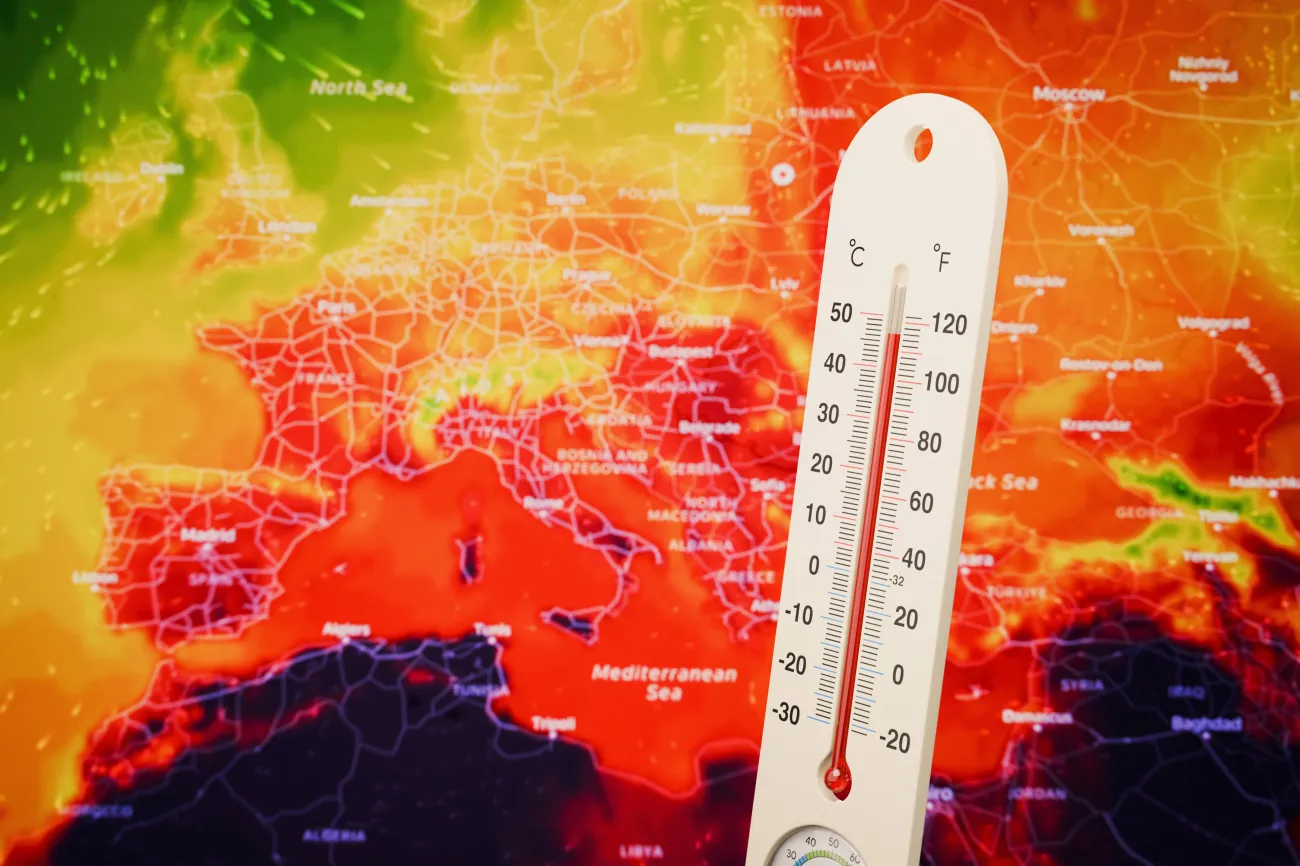 Thermometer showing extreme high temperature on a red European weather heat map background, symbolizing global warming, climate crisis, and severe summer heatwave in Europe. 