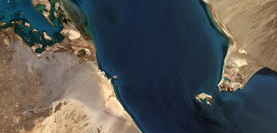 Bab al-Mandab Strait between Yemen, Djibouti and Eritrea, connecting the Red Sea to the Gulf of Aden. Little Doumeira Island is visible near the centre-left and Perim Island to the right.