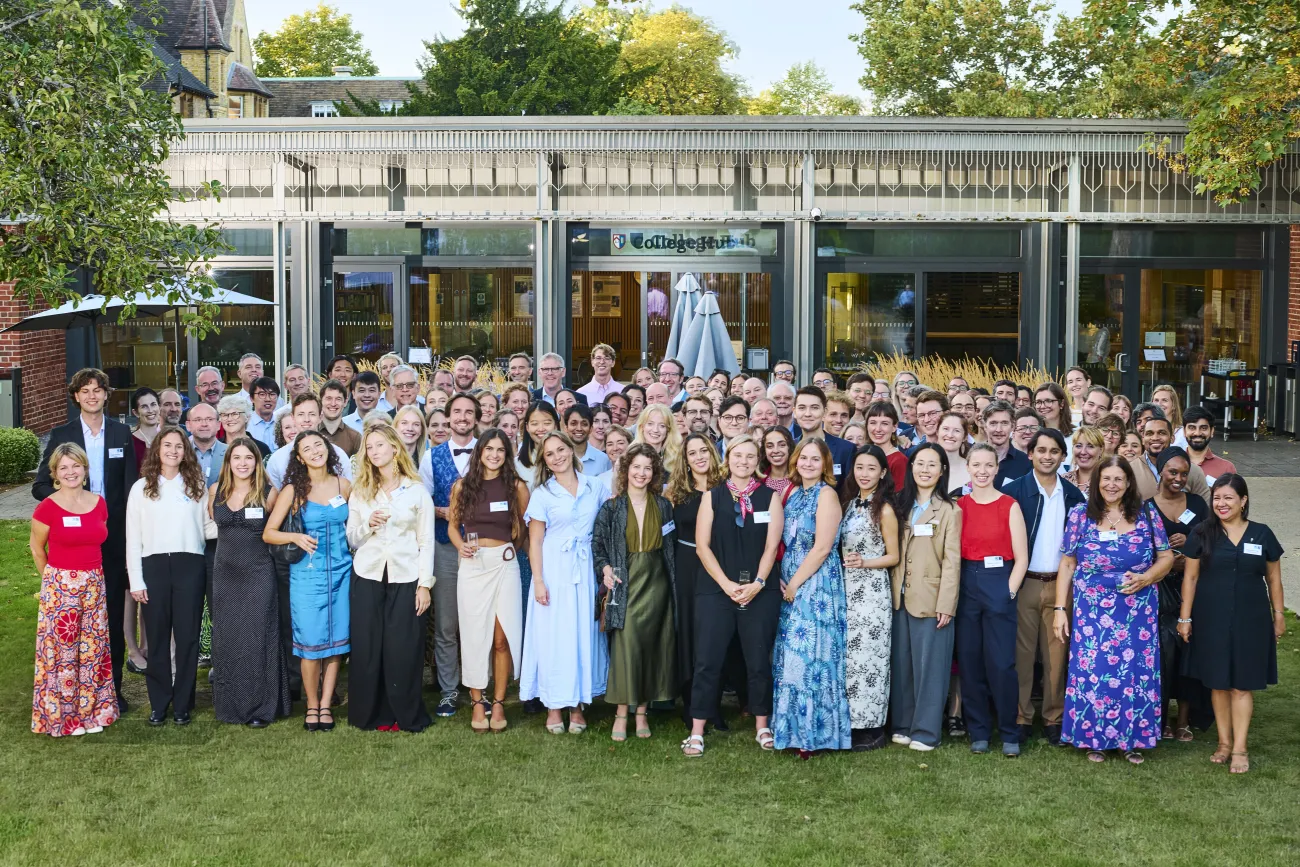Large group shot of everyone who attended the dinner standing outside Kellogg College