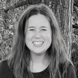Dr Bryony Parrish in front of a tree facing forwards and smiling